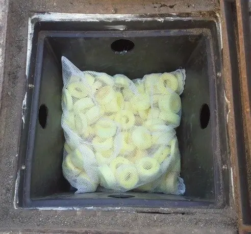 Bag of filter media snippets fitted inside a stormwater pit