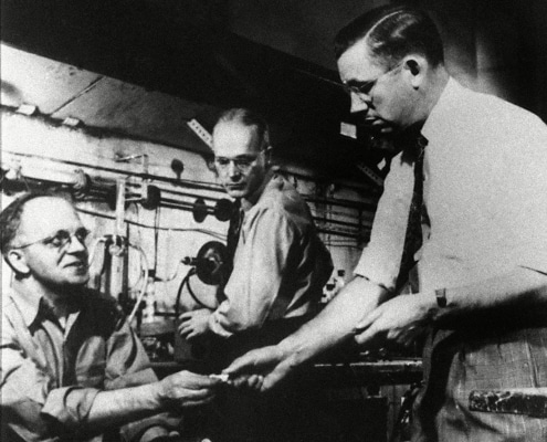 Dr. Roy J. Plunkett, right, holder of the original patent for Teflon, poses with his product and DuPont chemists re-enact the making of the product in one of the company's laboratory. Photo: AP/Shutterstock (6650656a)